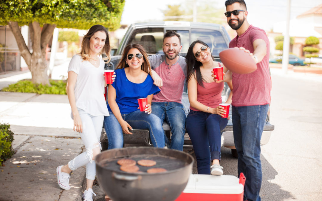 Football fans tailgating at a game and drinking - rent lawn games Raleigh NC